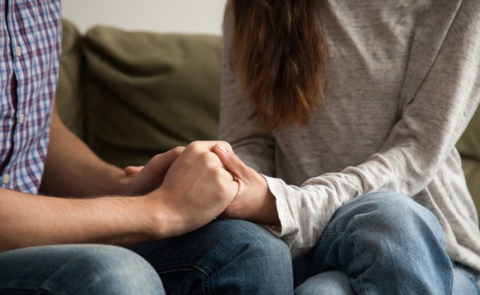 Close up of couple holding hands, support and understanding concept
